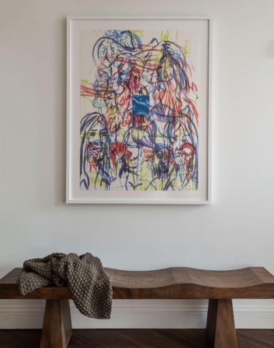 a painting on a white wall with a wooden bench at The Pinch Charleston in Charleston