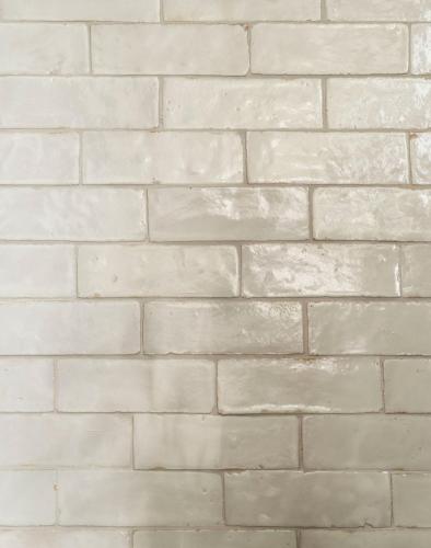 a white brick wall with at The Pinch Charleston in Charleston