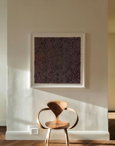 a chair in a room with a painting on the wall at The Pinch Charleston in Charleston
