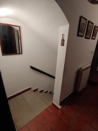 a hallway with a staircase with a tv on the wall at Casa Rural Sarrion in Teruel