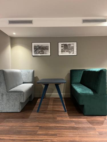a living room with a couch and a table at VTZ Hotel San Valero in Zaragoza