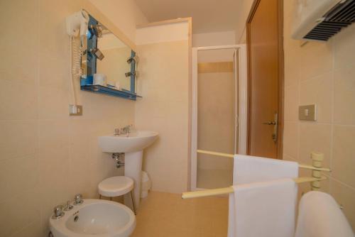 a bathroom with a sink and a toilet and a shower at Hotel Santa Maria in Assisi