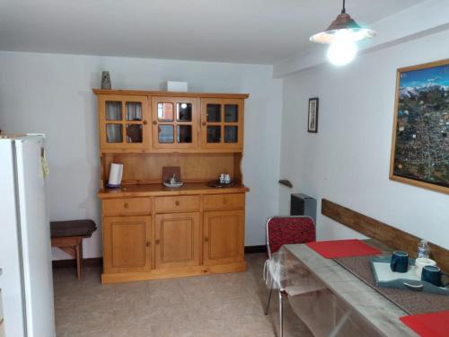a kitchen with a wooden cabinet in a room at Departamento E.M.A in Esquel