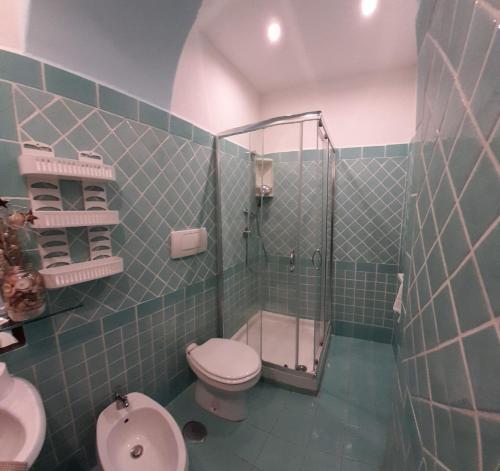 a bathroom with a shower and a toilet and a sink at Casa Vacanze Elianto in Anzio