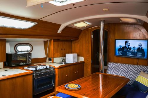 a kitchen with a stove and a table in a boat at Stay in a Boat - Lisboa in Lisbon