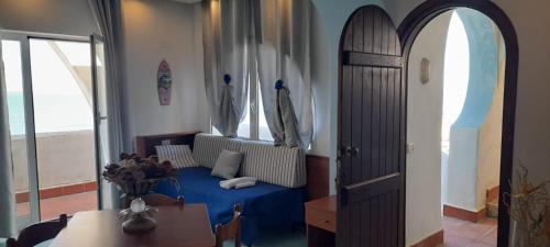 a living room with a blue bed and a window at Casa Vacanze Elianto in Anzio