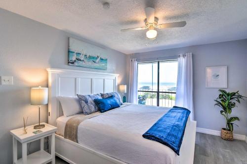 a bedroom with a bed with blue pillows and a window at Ocean-View Balcony: Family Gem on Seawall Blvd! in Galveston