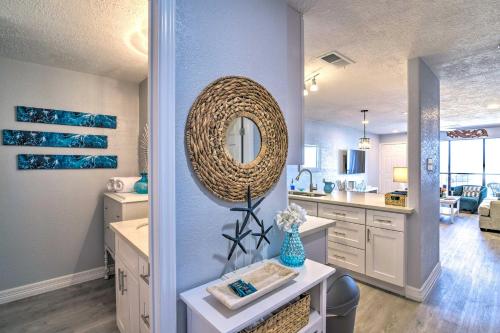 a bathroom with a sink and a mirror on the wall at Ocean-View Balcony: Family Gem on Seawall Blvd! in Galveston