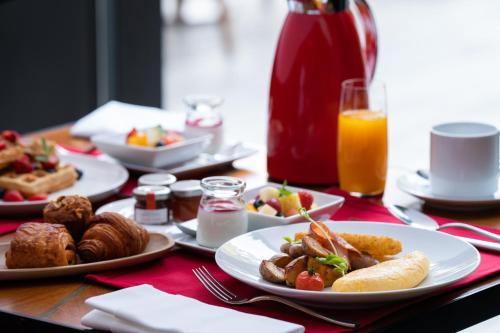 a table topped with plates of food and drinks at Four Seasons Hotel Kyoto in Kyoto