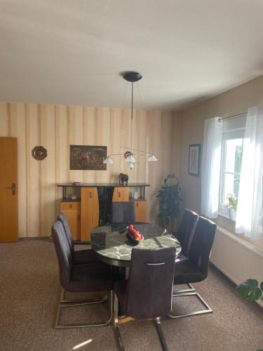 a dining room with a table and some chairs at Ferienhaus Mücheln in Mücheln