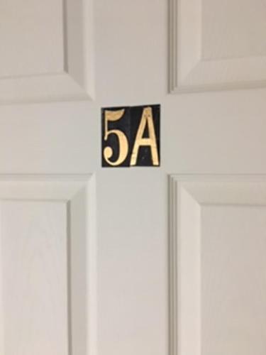 a clock on a door with the on it at Art Gallery Hostel in Whitefield