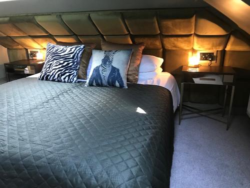 a bedroom with a bed with a zebra pillow on it at Amarillo Guesthouse in Bournemouth