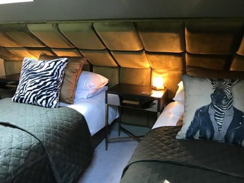 a room with two beds and a zebra on the pillow at Amarillo Guesthouse in Bournemouth