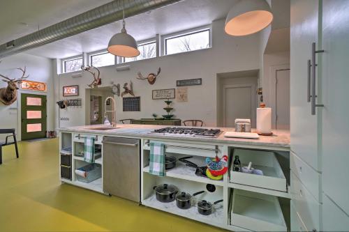 a kitchen with an island with a counter top at Bohemian Home with Screened Porch, 3 Mi to Lake! in Stillwater