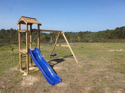 a playground with a blue slide and a tower at Quinta Reuffurth in Aljezur