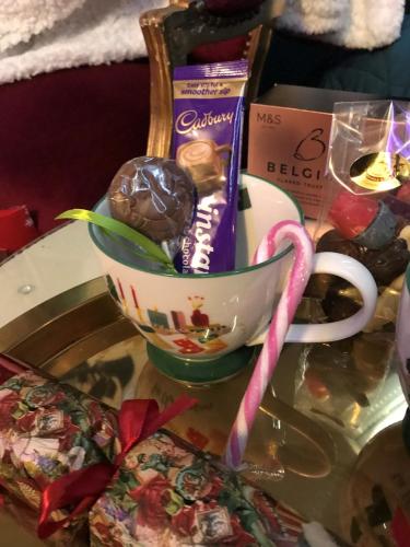 a cup of candy and a bag of chocolate at Amarillo Guesthouse in Bournemouth