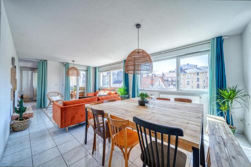 une salle à manger et un salon avec une table et des chaises dans l'établissement Le Reverso, T6 en duplex & vue incroyable, à Grenoble