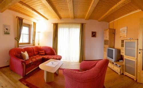 a living room with a couch and two chairs at Almhaus Karantanien in Hochrindl