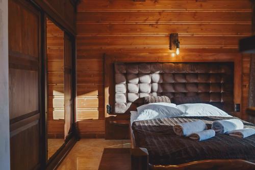 a bedroom with a bed in a wooden room at TatrApart in Zakopane