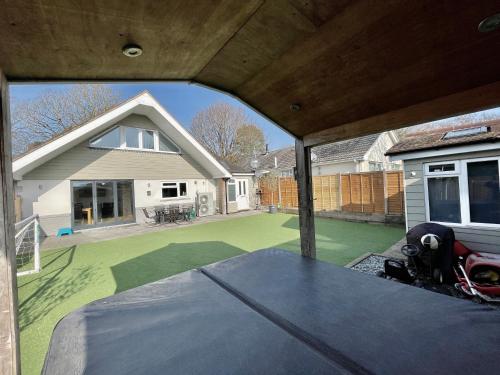 a view from the inside of a house with a patio at Luxury Pamper Home Hot Tub & Sauna Ladies Retreat in Ferndown