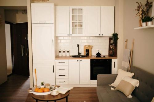 a living room with a couch and a bowl of fruit on a table at VIP apartments Bitola in Bitola