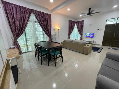 a living room with a table and a couch at Arwaa Homestay Beachview in Bachok