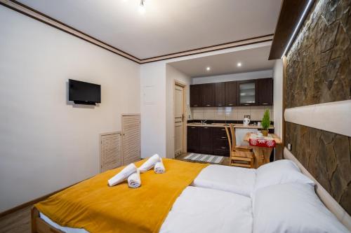a bedroom with a bed with towels on it at Domek u Świerków in Chochołów
