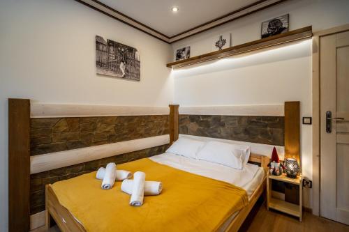 a bedroom with two towels on a bed at Domek u Świerków in Chochołów