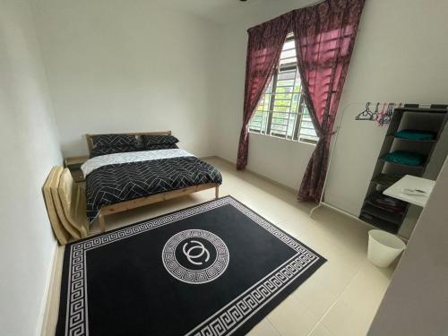 a bedroom with two beds and a rug on the floor at Arwaa Homestay Beachview in Bachok