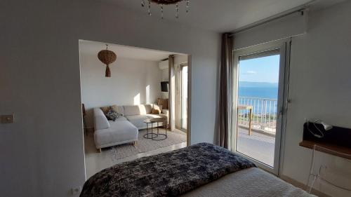 une chambre avec un lit et une vue sur l'océan dans l'établissement Un balcon sur la mer, à Ajaccio