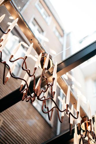 a group of lights hanging in a store window at Le Temple De Jeanne in Paris