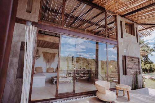 a room with a large glass window and a tub at Ginger and Coco in Tandil