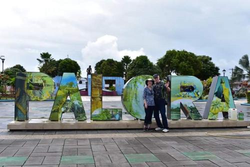 two people standing in front of a sign that reads amazon at AMUNTAI RAINFOREST LODGE in Palora