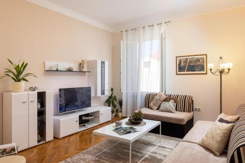 a living room with a couch and a tv at Villa Falkoni II in Dubrovnik