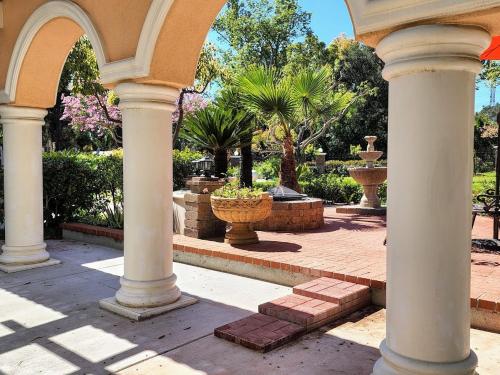 an archway of a building with trees and plants at 628 Madre Street in Pasadena