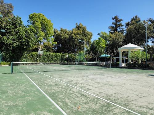 a tennis court with a net and a gazebo at 628 Madre Street in Pasadena