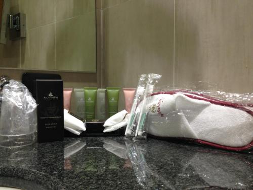 a bathroom counter with toothbrushes and a bottle on it at Green Hotel Ninfa in Avigliana