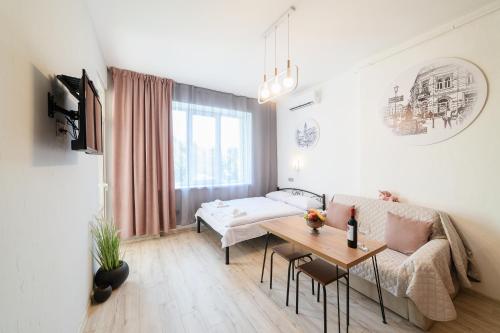 a living room with a couch and a table at Затишні смарт-квартири в історичному центрі! in Uzhhorod