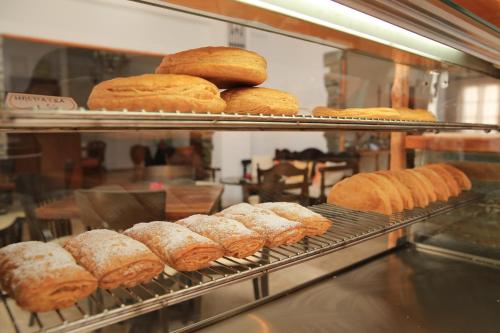 a bunch of donuts on a rack in a bakery at Sifnos Hotel Benaki in Platis Yialos Sifnos