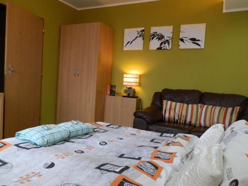 a bedroom with a bed and a couch at Hotel Gól Prostějov in Prostějov