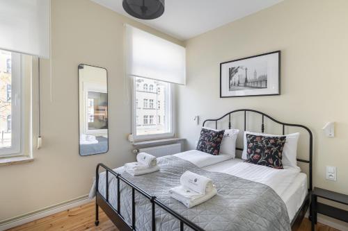 ein Schlafzimmer mit einem Bett mit Handtüchern darauf in der Unterkunft Lion Apartments - London in Sopot