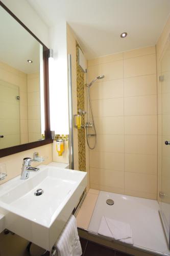 a bathroom with a sink and a shower at Best Western Hotel Kaiserhof in Bonn