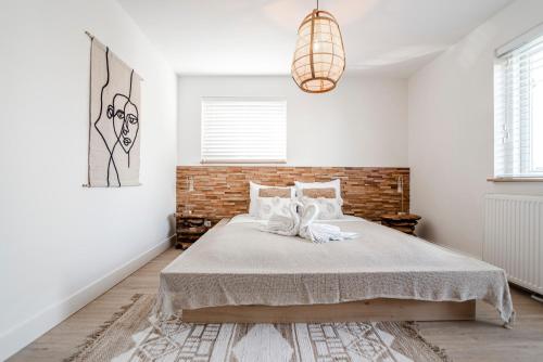 a bedroom with a bed and a brick wall at Marley’s Beachhouse - Luxury Guest Room with balcony in Zandvoort