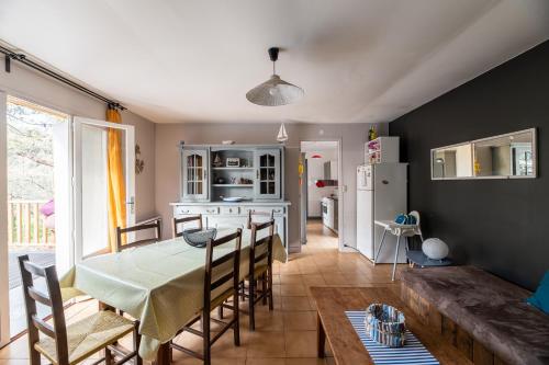 une cuisine et une salle à manger avec une table et des chaises dans l'établissement LA PETITE MAISON DU LAC, à Biscarrosse
