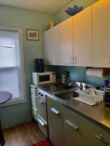 a kitchen with a sink and a microwave at The Insight room is well-appointed in Pawtucket
