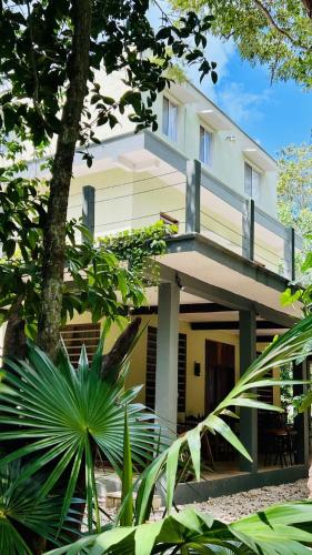 a building with a balcony in front of it at Hokhmah Heart Hotel in Puerto Morelos