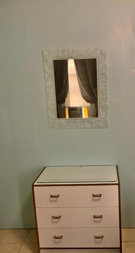 a dresser with a mirror on a wall at The Insight room is well-appointed in Pawtucket