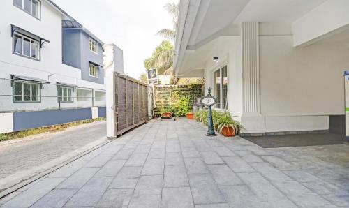 a courtyard of a building with a gate and plants at Treebo Anchor Inn in Cochin