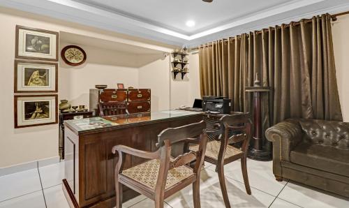 a home office with a desk and a chair at Treebo Anchor Inn in Cochin