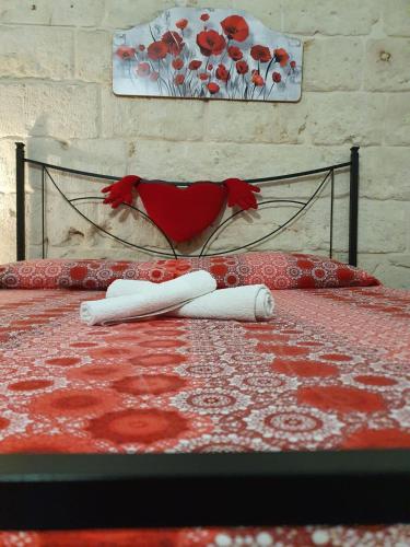 a bedroom with a bed with a red and white rug at Lungomare Modugno in Polignano a Mare